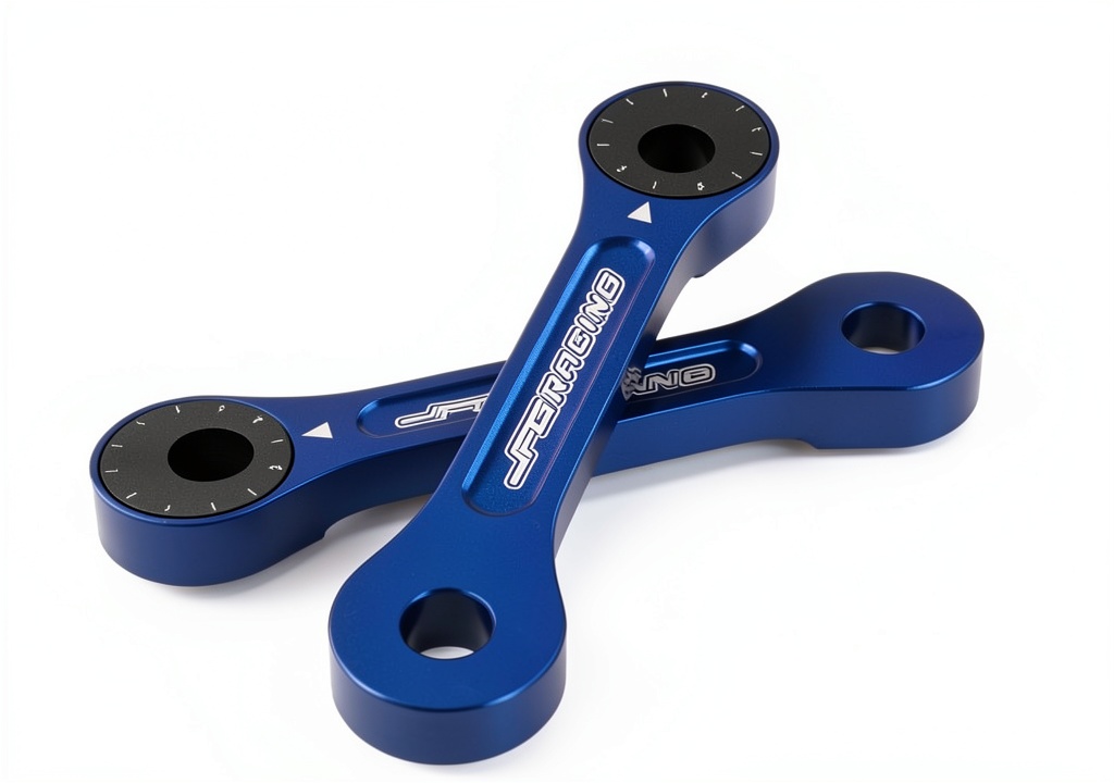 JFG RACING DRZ400 lowering kit components laid out on a workbench